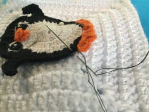 Attaching appliques to items sewing on penguin