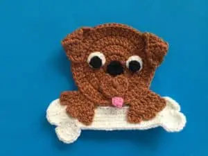 Finished crochet dog with a bone landscape